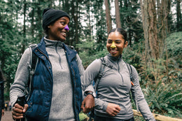 Two black women walking in nature with Noz SPF colorful sunscreen applied to their face 